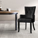 Diagonal View of the Artiss French Provincial Dining Chair in Velvet Black next to a table in an Indoor Setting