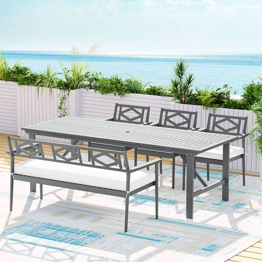 The Gardeon Acacia Wood 5pcs Outdoor Dining Set in an Outdoor Setting with the Ocean in the Background
