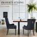 The La Bella Velvet Black French Provincial Dining Chair set in an indoor setting, around a coffee table resting on a timber floor, in front of a white wall with a large window. A lounge room off to the side on the left.